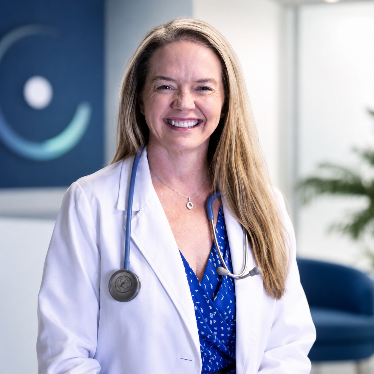 Angela Jayes, NP smiling in a modern clinic setting